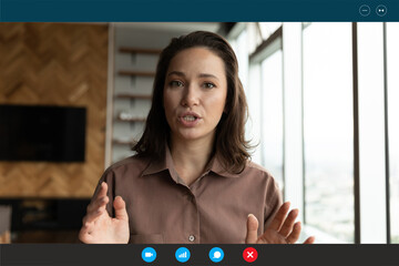 Screen view of motivated young Caucasian female teacher or trainer talk speak on video call. Woman...