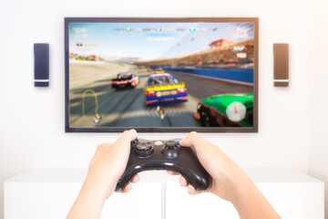 Player playing console car race videogame holding gamepad - high key image
