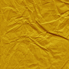 Yellow vintage and old looking crumpled paper background. Retro cardboard texture. Grunge paper for drawing. Ancient book page. Present wrapping.