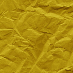 Yellow vintage and old looking crumpled paper background. Retro cardboard texture. Grunge paper for drawing. Ancient book page. Present wrapping.