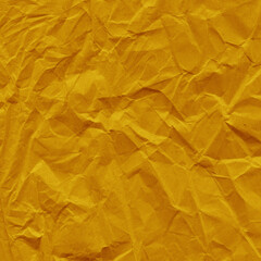 Yellow vintage and old looking crumpled paper background. Retro cardboard texture. Grunge paper for drawing. Ancient book page. Present wrapping.