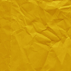 Yellow vintage and old looking crumpled paper background. Retro cardboard texture. Grunge paper for drawing. Ancient book page. Present wrapping.
