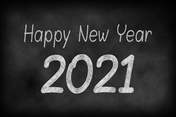 Obraz premium Happy New Year 2021 on a chalkboard background