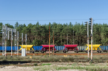 Fototapeta na wymiar WAGONS WITH CRUSHED STONE - Color railway on the sidetrack