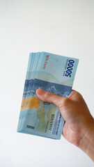 Indonesian rupiah currency, around 50,000 Indonesian money, is held by women's hands