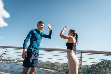 Man and woman making sport training outdoors together