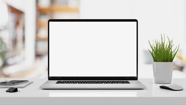 Laptop with blank screen smooth zoom in - white table with mouse and smartphone. Home interior or office background, 4k 30fps UHD