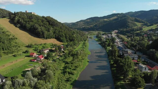 Flying over Poprad river in summer. Beskid Mountains, village Rytro, Poland.
