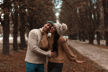 Young couple having fun in the autumn park. Love couple. Autumn. Romantic lovers. 
