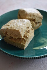 Two biscuits or scones on a green plate