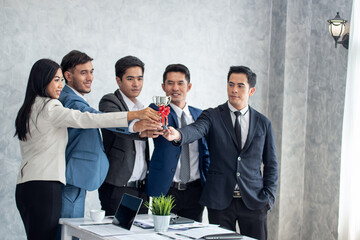 Business team winning trophy in the office, Asian businessman showing trophy and reward of success