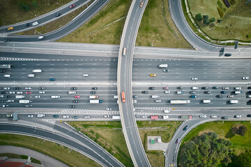 Top down view from drone on overpass with road traffic. Cloudy weather.