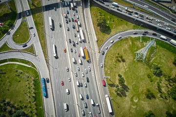 Traffic on highway with overpasses and exits. Big intersection. Shot from above.