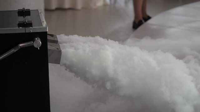 The smoke machine releases a large cloud of smoke onto the stage