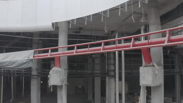Internal structure urban architecture futuristic construction. Abstract detail of futuristic architecture. Moving inside ruined and abandoned  industrial factory. Old roller coaster