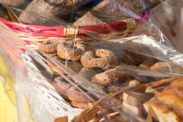 Homemade biscuits ciambelli with sugar on top and other bakery packed in baskets with transparent...