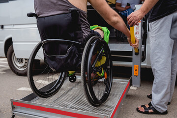 Fototapeta premium Disabled man on wheelchair using accessible vehicle with lift mechanism.