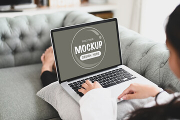 Cropped shot of a girl using a laptop on couch in the living room. For graphics display montage.