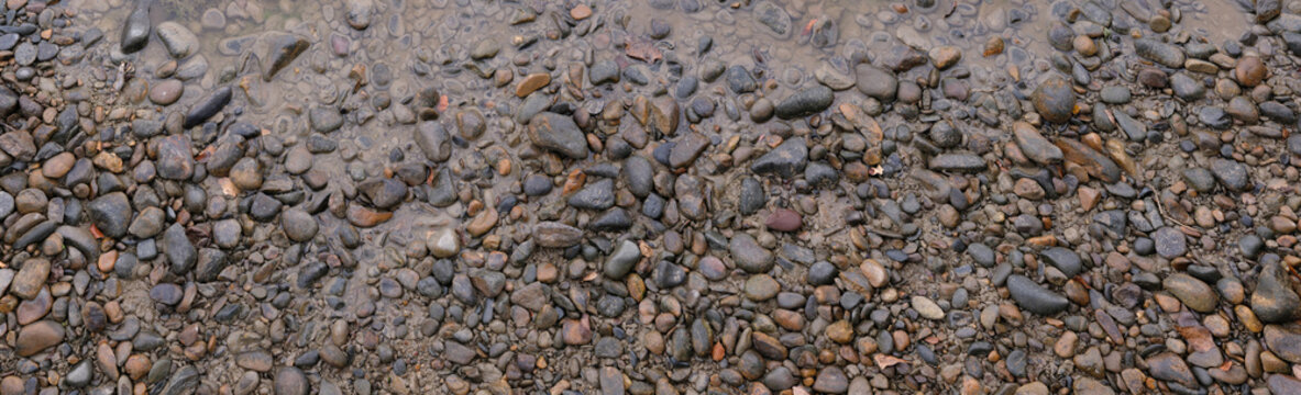texture of wet stones river bank