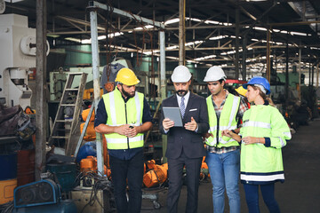 Leader or manager using tablet and meeting with engineer and technician while line walk in factory workplace, team wear face mask whine working at maintenance machine shop 