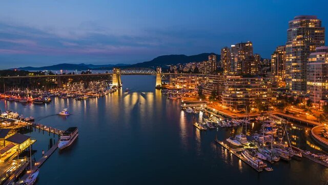 Vancouver, British Columbia, Canada, zoom in timelapse view of boats on False Creek and Downtown buildings at dusk.