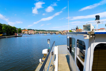 Fototapeta na wymiar River Vltava with Charles Bridge in the background view from the deck of the tourist boat, sightseeing cruise in Prague, Czech Republic, boheman region.