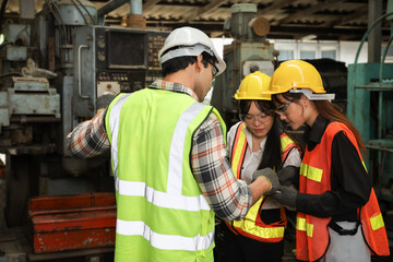 Leader supervisor training with new engineer and technician while working or operate in factory, team adjust and control at maintenance machine shop 