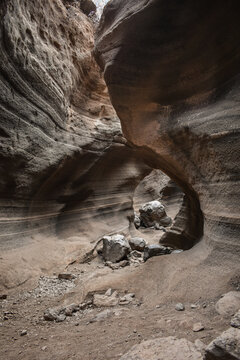 Tobas de Colores, Barranco de las Vacas, Gran Canaria, large mountains made of smooth and colorful stone.