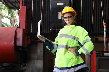 A Engineer woman using tablet or computer for inspect or checking or adjust or operate control the machine in workshop factory, the technician repair or maintenance part or equipment 