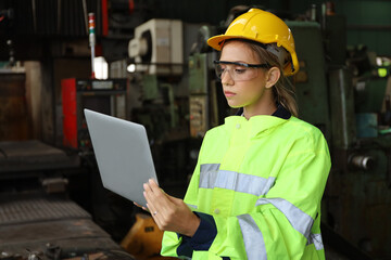 A Engineer woman using tablet or computer for inspect or checking or adjust or operate control the machine in workshop factory, the technician repair or maintenance part or equipment 