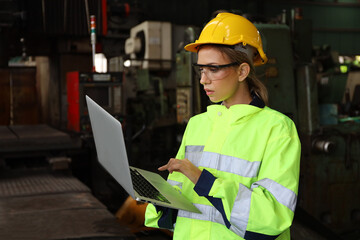 A Engineer woman using tablet or computer for inspect or checking or adjust or operate control the machine in workshop factory, the technician repair or maintenance part or equipment 