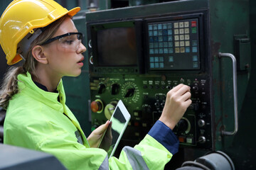 A Engineer woman using tablet or computer for inspect or checking or adjust or operate control the machine in workshop factory, the technician repair or maintenance part or equipment 