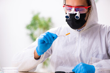 Male expert criminologist working in the lab for evidence