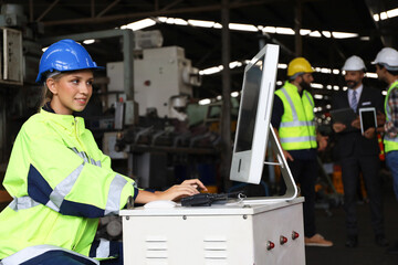 Lady engineer or worker is working in factory with using computer and radio for operate and communication