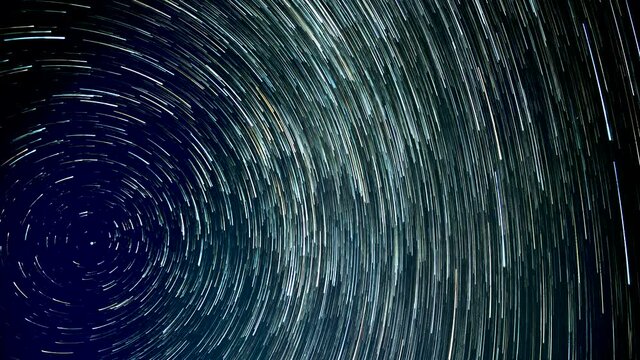 Stars move around a polar star. Time lapse of Star trails in the night sky. 4K
