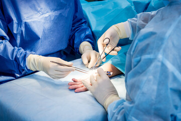 Surgeons in the operating room trying to save the patient's hand.