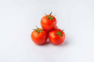 Three tomatoes on a white background