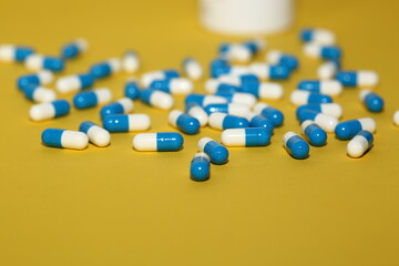 Capsules / pills on a yellow background