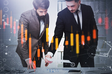 Two traders in office, financial graph