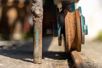 A rusty wheel from sliding gate on a rail, close up view