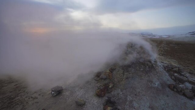 Námaskarð Geothermal Area, North Iceland. Steam coming from an old borehole at sunrise blowing around in strong wind.