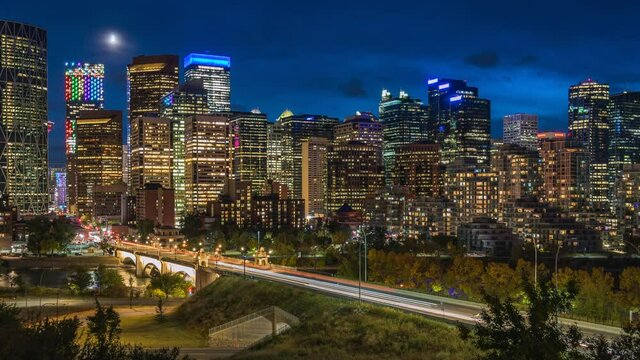 Calgary, Alberta, Canada, zoom in time lapse view of Calgary skyline showing high rise buildings in the financial district at dusk.