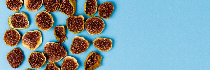 slices of dried figs on a blue background. dried fruits. eco.