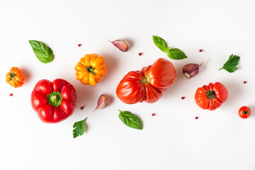 Tomato, basil, spices, pepper, garlic. Vegan diet food. Creative composition on isolated white background. top view