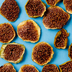 slices of dried figs on a blue background. dried fruits. eco.