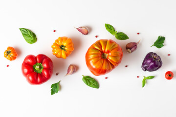 Tomato, basil, spices, pepper, garlic. Vegan diet food. Colorful organic tomato composition on white background