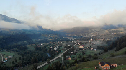 Mountain green hill valley village view. Mountain village landscape. Village in mountains.