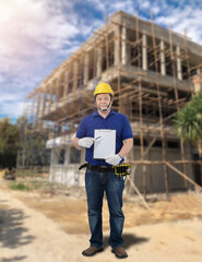Obraz na płótnie Canvas Male Building contractor Sign the signature on the Construction progress form