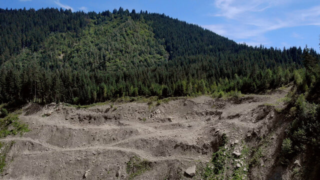 Sandy cliff with trees on it. Landscape of beautiful mountains.