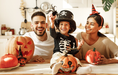 Happy multi ethnic family preparing for Halloween celebration.